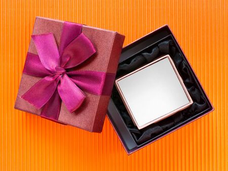 Open nested gift boxes on bright orange corrugated cardboard. Top view. Clipping path included