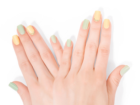 Two woman hands with art shellac manicure and rhinestones. Isolated on white, clipping path includedの写真素材