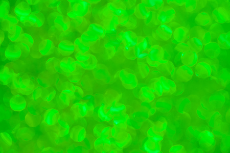 Green defocused background with blurred glittersの写真素材