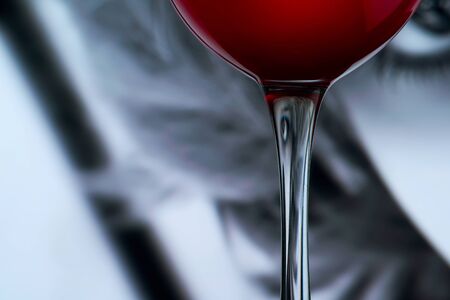 Distorted face into wine glass stem. Surreal presence conceptの写真素材