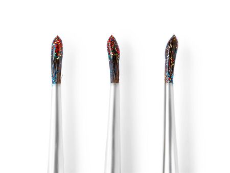 Set of three wet brushes with colored glitters. Isolated on white with clipping pathの写真素材