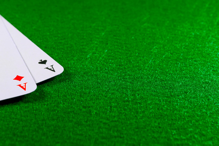 Two aces on the green felt casino table. Copy space on felt fieldの写真素材