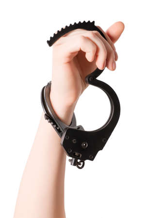 Female hand with handcuffs. Isolated on white, clipping path includedの写真素材