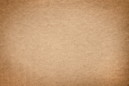 Yellow cardboard close up with vignette. Texture and backgroundの写真素材