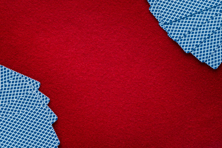 Cards over red felt. Abstract background with copy space. Gambling, poker, blackjack and casino themeの写真素材