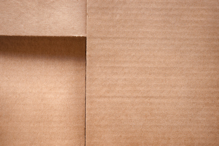 Folded cardboard box cover close up. Texture and background with copy spaceの写真素材