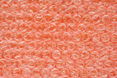 Orange air bubble wrap close up. Plastic surface of shock proof packing. Texture and background