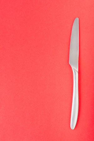 Table knife on yellow background, top view. Sparse food theme templateの写真素材