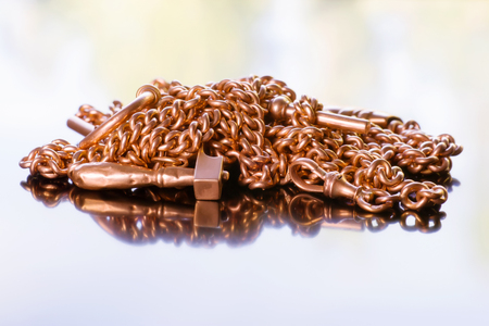 Ancient golden chain and charm. On abstract background with reflectionの写真素材
