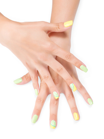 Hands with citrus theme art manicure. Isolated on white, clipping path includedの写真素材