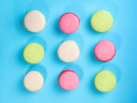 Colored macaroons on blue background. Top viewの写真素材