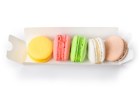 Colorful macaroons set into cardboard box. Isolated on white, clipping path includedの写真素材