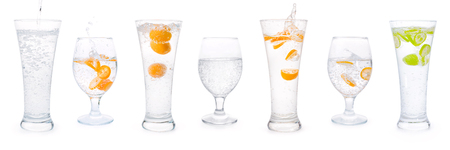 Glasses with clear sparkling water, citrus fruits splashes and bubbles set. Isolated on white, clipping path includedの写真素材