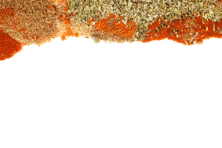 Different spices and herbs laying on white background as border. Texture and templateの写真素材
