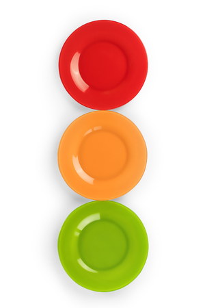 Three colored plates, red, yellow and green, arranged as traffic light. Isolated on white, clipping path included
の写真素材