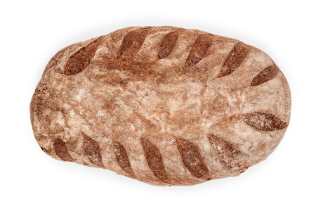 Loaf of brown craft bread close up. Top view isolated on white, clipping path includedの写真素材