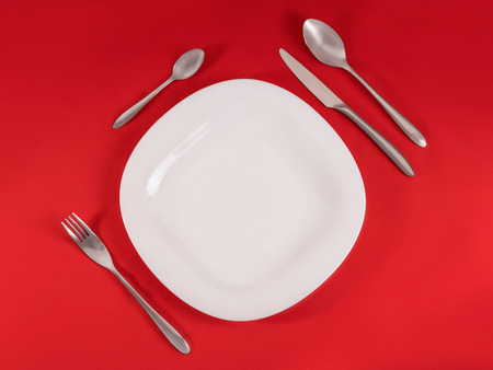 Perfect modern table setting on red napkin background. Top view, diagonal compositionの写真素材