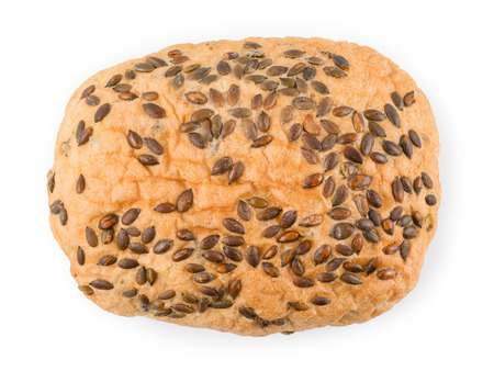 Loaf of white craft bread with seeds. Top view isolated on white with clipping pathの写真素材