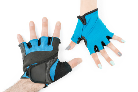 Man and woman hands in blue cycling or fitness gloves. Isolated on whiteの写真素材