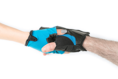 Man and woman hands weared in blue sport gloves handshake. Isolated on whiteの写真素材