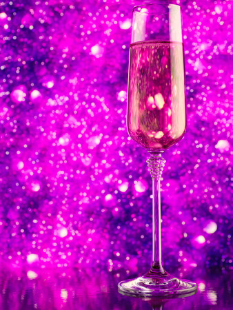 Glass of sparkling wine against purple abstract defocused backgroundの写真素材