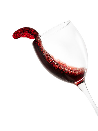 Red wine glass with splash. Isolated on white, clipping path includedの写真素材