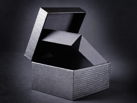 Open black box on black background.