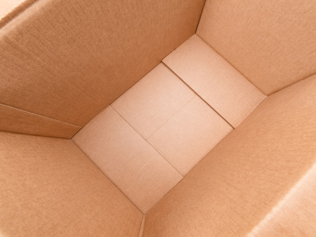 Wide angle diagonal view inside large rough cardboard boxの写真素材