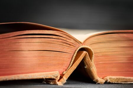 Open ancient book on wooden table close up. Selective focusの写真素材