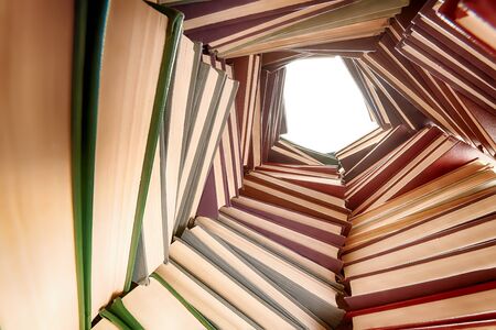 Large hardcover books pile. Wide angle view from insideの写真素材
