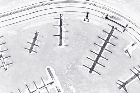 Empty winter marina aerial view. High key black and white photo