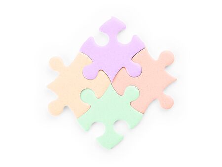 Four colored puzzle pieces. Isolated on white, clipping path includedの写真素材
