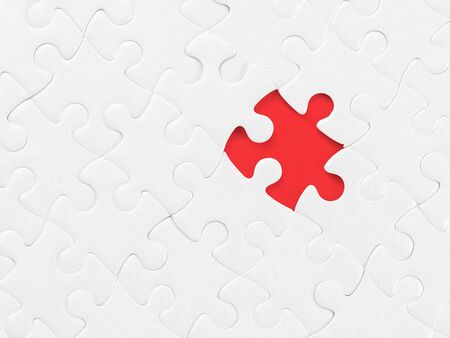 White blank jigsaw puzzle without one piece on red. Clipping path on the missing piece. Missing part, organization and solution themeの写真素材