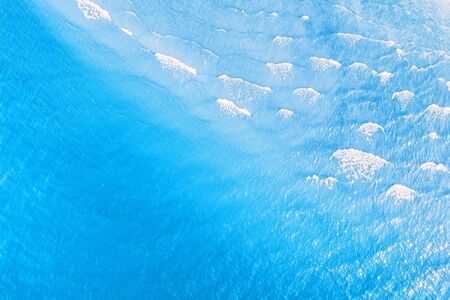Bright blue tropical sea with waves aerial view. Natural texture and backgroundの写真素材