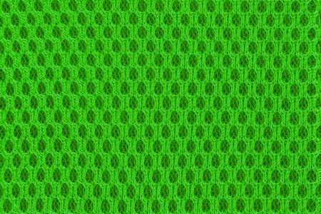 Green modern poriferous material close up. Sportswear material for abstract background and textureの写真素材