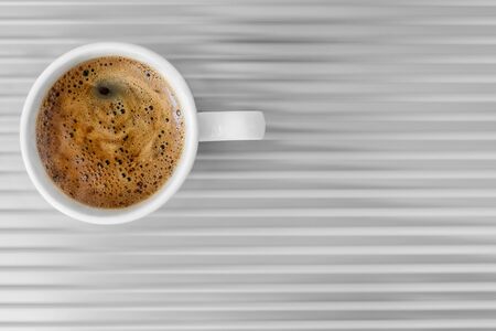 White coffee cup on gray table top view. Sparse composition with copy spaceの写真素材