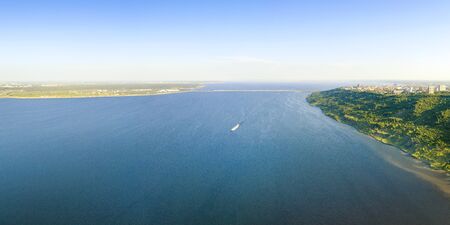 Volga river panoramic aerial view with distant shores and white boat. Ulyanovsk, Russiaの写真素材
