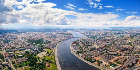 Aerial panoramic view of Neva river in Saimt Petersburg, Russia. Large wide angle cityscape with dramatic cloudy skyの写真素材