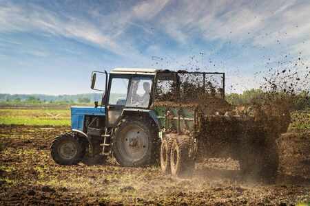 Field tractor at work. Rural industrial landscape