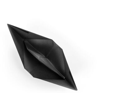 Black paper boat top view isolated on white with copy spaceの写真素材