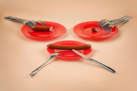 Three plates, three different sausage portions and many forks. Metaphor for disproportion and inequality in allocating budget, wages, resources, funds, finances, goods or assistanceの写真素材