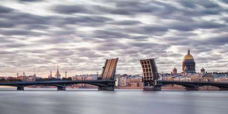 Neva river in Saint Petersburg panoramic view with divorced Blagoveshchenskiy bridge, st. Isaak cathedral and Admiralty at white nights. Long exposureの写真素材