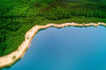Idyllic turquoise colored lake in the forest. Panoramic aerial landscapeの写真素材