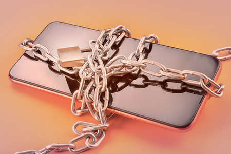 Smart phone in chain with lock on orange background with selective focus. Security, data protection,...