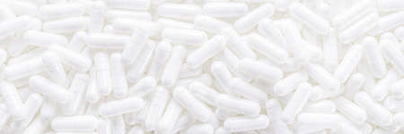 Long panoramic background with whites medical capsules. Top panoramic view