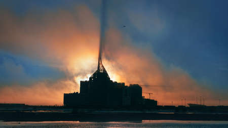 Dark silhouette of large building construction in the open field at sunset. Dark surreal industrial...