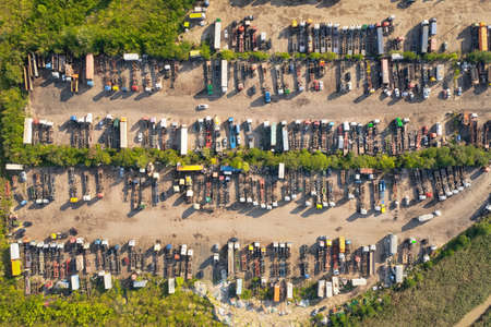 Large truck parking on a country road surrounded by green bushes. Aerial top viewの写真素材