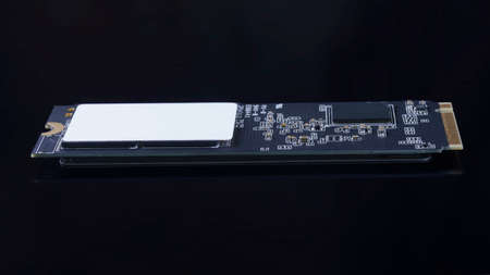SSD M2 disk close up side view. On dark background with reflectionの写真素材
