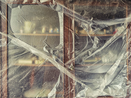 Antique display case with antiques covered with plastic wrap. Abstract image on the theme of antiquity, collectibles and home renovationの写真素材
