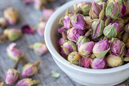 Dried pink roses on the wooden background. Dried pink roses herbal tea.の写真素材